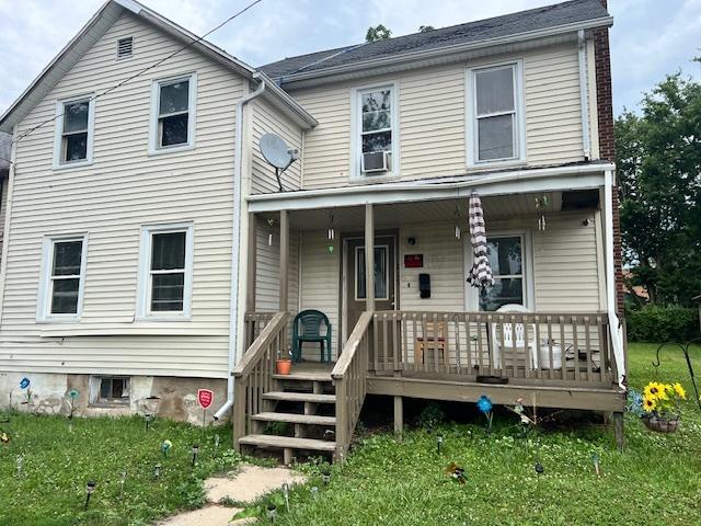 717 S Chicago Ave, Freeport, IL 61032 - view of front of property with a porch, a front yard, and cooling unit