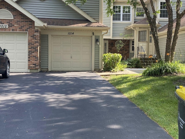 1014 Rockport Dr, Carol Stream, IL 60188 - view of front of house with brick siding, a garage, and asphalt driveway