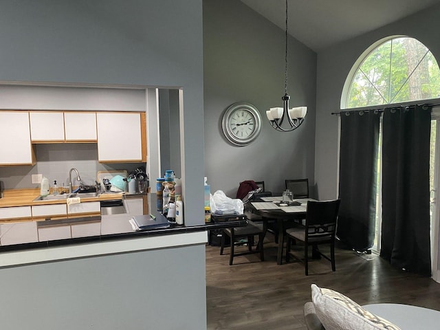 1014 Rockport Dr, Carol Stream, IL 60188 - kitchen featuring high vaulted ceiling, a chandelier, dark wood finished floors, white cabinetry, and light countertops