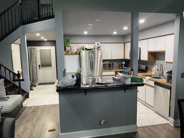 1014 Rockport Dr, Carol Stream, IL 60188 - kitchen with appliances with stainless steel finishes, light wood-style floors, white cabinetry, recessed lighting, and a center island