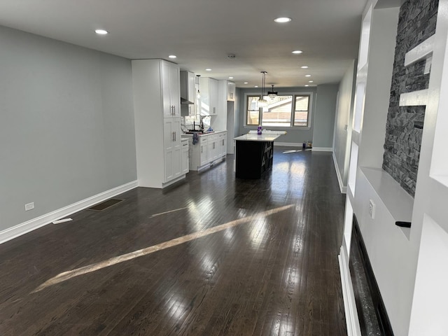 12152 S Union Ave, Chicago, IL 60628 - unfurnished living room with dark wood finished floors, recessed lighting, and a stone fireplace