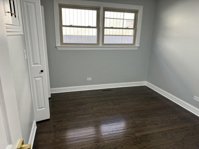 12152 S Union Ave, Chicago, IL 60628 - unfurnished bedroom with baseboards and dark wood-type flooring