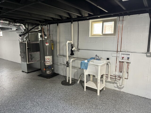 12152 S Union Ave, Chicago, IL 60628 - below grade area with gas water heater, heating unit, and drainage system