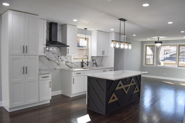 12152 S Union Ave, Chicago, IL 60628 - kitchen featuring wall chimney range hood, healthy amount of natural light, backsplash, recessed lighting, and white cabinets