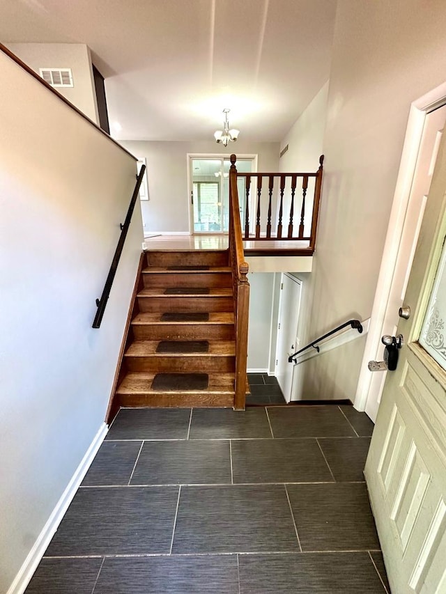 899 Carl Ave, Elgin, IL 60120 - staircase featuring a chandelier and tile patterned floors