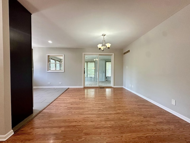 899 Carl Ave, Elgin, IL 60120 - empty room featuring a chandelier, wood finished floors, and recessed lighting