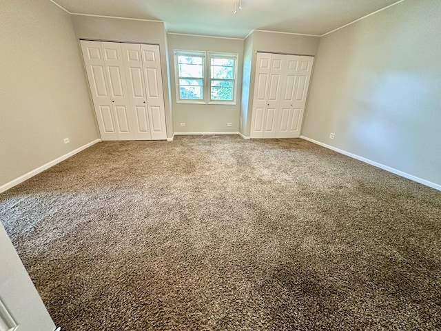 899 Carl Ave, Elgin, IL 60120 - unfurnished bedroom with multiple closets, ornamental molding, and carpet floors