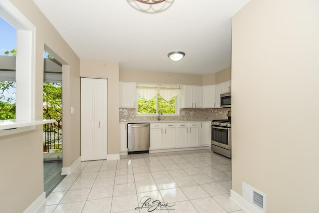 18100 Rita Rd Unit 3B, Tinley Park, IL 60477 - kitchen featuring appliances with stainless steel finishes, tasteful backsplash, light countertops, white cabinetry, and light tile patterned floors
