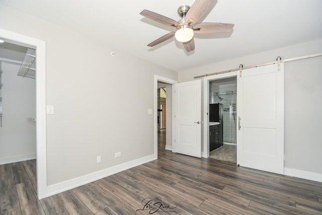 18100 Rita Rd Unit 3B, Tinley Park, IL 60477 - unfurnished bedroom with a spacious closet, dark wood-style flooring, and a barn door