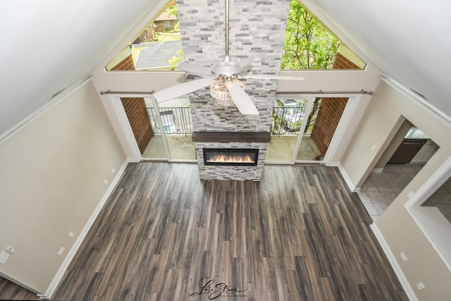 18100 Rita Rd Unit 3B, Tinley Park, IL 60477 - unfurnished living room featuring a ceiling fan, a towering ceiling, a tile fireplace, and wood finished floors