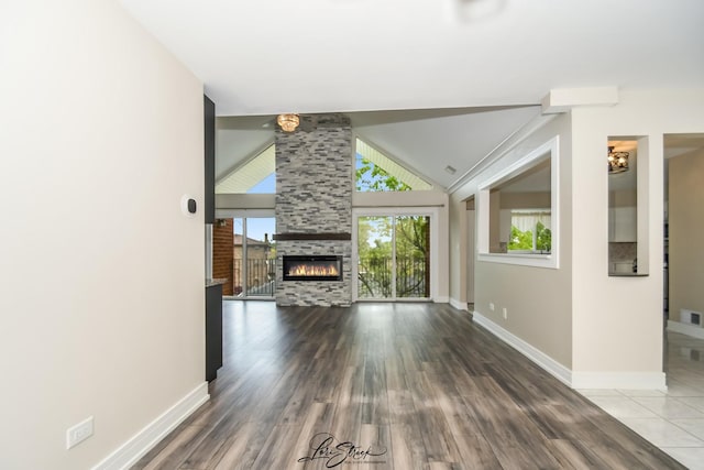 18100 Rita Rd Unit 3B, Tinley Park, IL 60477 - unfurnished living room featuring wood finished floors, lofted ceiling, and a tiled fireplace