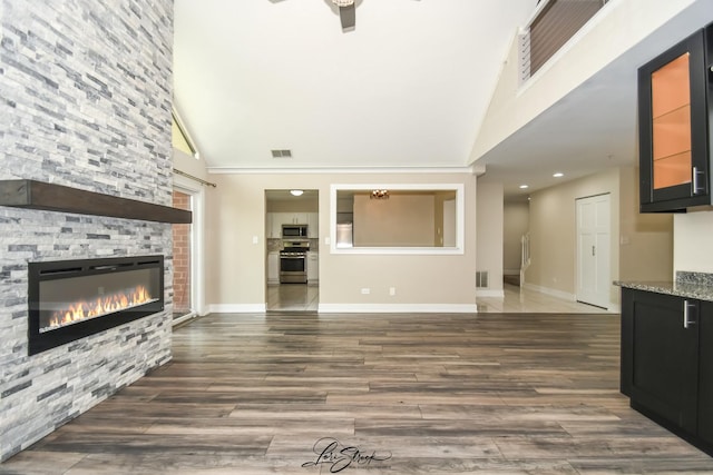 18100 Rita Rd Unit 3B, Tinley Park, IL 60477 - unfurnished living room featuring high vaulted ceiling, a fireplace, a ceiling fan, wood finished floors, and recessed lighting