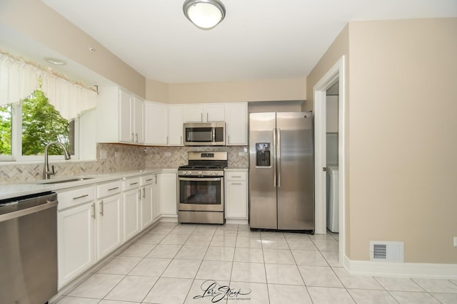 18100 Rita Rd Unit 3B, Tinley Park, IL 60477 - kitchen with appliances with stainless steel finishes, light countertops, backsplash, and white cabinetry