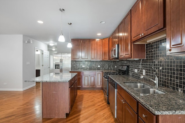 2726 W Thomas St, Chicago, IL 60622 - kitchen with stainless steel appliances, light wood-type flooring, a center island, backsplash, and hanging light fixtures
