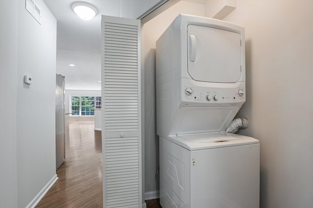 2726 W Thomas St, Chicago, IL 60622 - laundry area with stacked washer and clothes dryer, wood finished floors, and recessed lighting