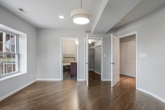 2726 W Thomas St, Chicago, IL 60622 - unfurnished bedroom featuring a walk in closet, wood finished floors, a closet, and connected bathroom