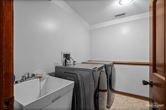 116 Pipers Dr, Bartlett, IL 60103 - laundry room with washer and dryer, crown molding, and light tile patterned floors
