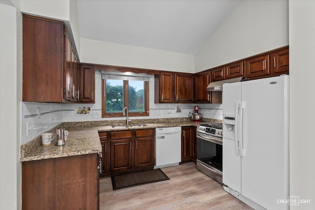 116 Pipers Dr, Bartlett, IL 60103 - kitchen with white appliances, under cabinet range hood, backsplash, light wood-type flooring, and light stone counters