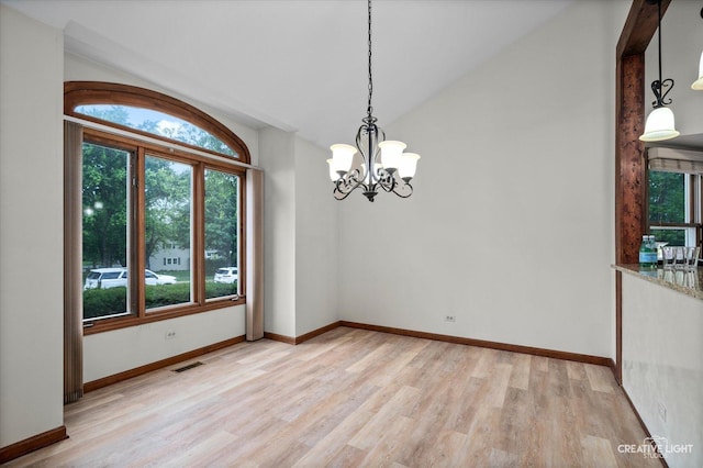 116 Pipers Dr, Bartlett, IL 60103 - unfurnished room with healthy amount of natural light, a chandelier, light wood-style flooring, and lofted ceiling