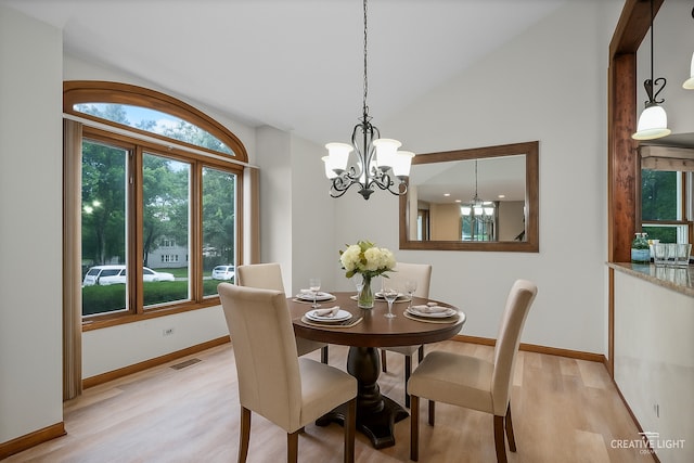 116 Pipers Dr, Bartlett, IL 60103 - dining area with healthy amount of natural light, vaulted ceiling, a chandelier, and light wood-type flooring