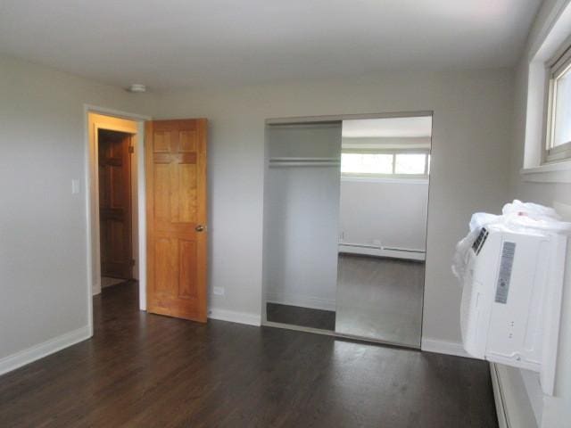 2012 W 111th St Unit 3S, Chicago, IL 60643 - unfurnished bedroom featuring a baseboard heating unit, wood finished floors, and a closet