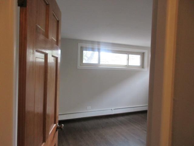 2012 W 111th St Unit 3S, Chicago, IL 60643 - unfurnished room featuring baseboard heating and dark wood-type flooring