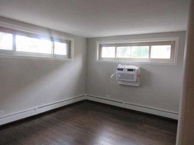 2012 W 111th St Unit 3S, Chicago, IL 60643 - spare room featuring a wall mounted air conditioner and dark wood-style flooring