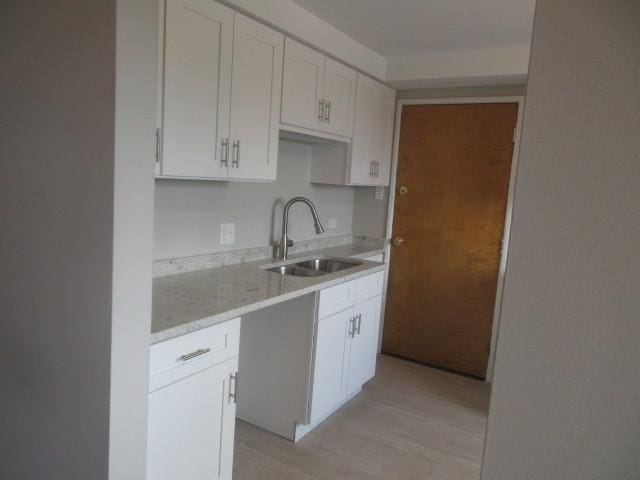 2012 W 111th St Unit 3S, Chicago, IL 60643 - kitchen with white cabinets, light wood finished floors, and light stone counters
