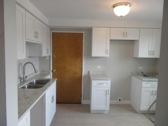 2012 W 111th St Unit 3S, Chicago, IL 60643 - kitchen with light stone countertops and white cabinetry