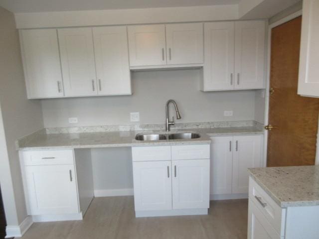 2012 W 111th St Unit 3S, Chicago, IL 60643 - kitchen with white cabinetry, light wood-style flooring, and light stone countertops