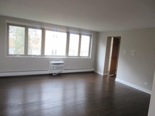 2012 W 111th St Unit 3S, Chicago, IL 60643 - unfurnished room with healthy amount of natural light, dark wood finished floors, and a wall mounted air conditioner