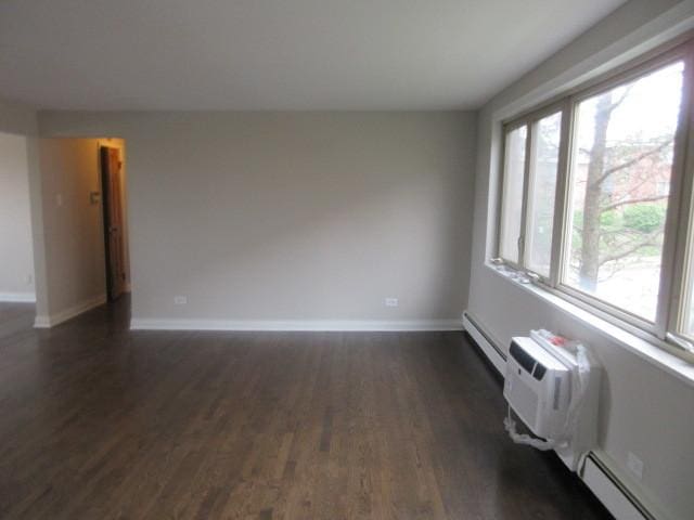 2012 W 111th St Unit 3S, Chicago, IL 60643 - unfurnished room featuring dark wood-style flooring, a baseboard heating unit, and baseboard heating