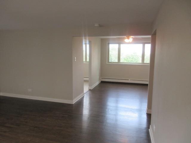2012 W 111th St Unit 3S, Chicago, IL 60643 - empty room with baseboard heating, dark wood-style floors, and ceiling fan