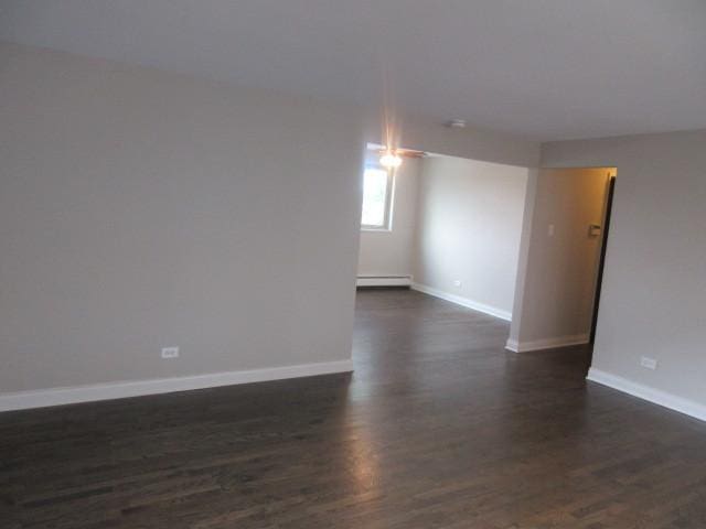 2012 W 111th St Unit 3S, Chicago, IL 60643 - empty room featuring a baseboard heating unit and dark wood-style flooring
