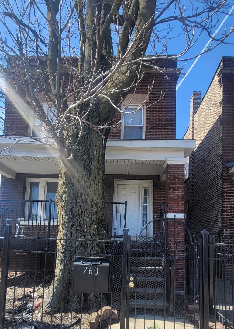 760 S Kostner Ave, Chicago, IL 60624 - view of front of house featuring brick siding, a fenced front yard, and a gate