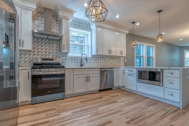 4826 W Potomac Ave, Chicago, IL 60651 - kitchen featuring stainless steel appliances, wall chimney exhaust hood, light countertops, and recessed lighting