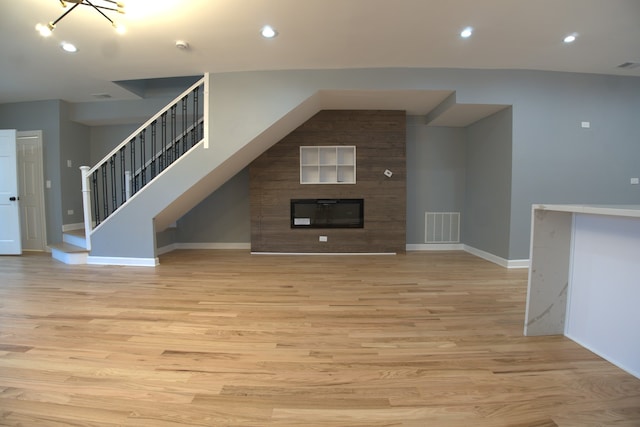 4826 W Potomac Ave, Chicago, IL 60651 - unfurnished living room with a fireplace, light wood-style flooring, and recessed lighting