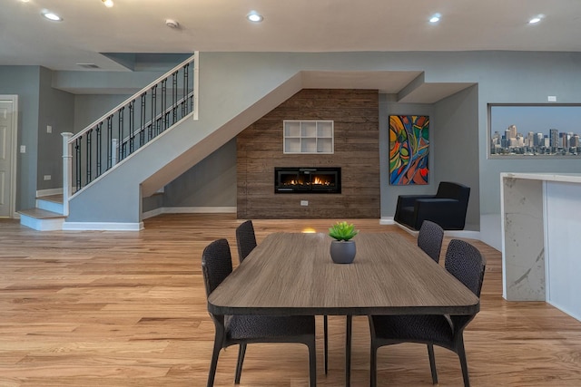 4826 W Potomac Ave, Chicago, IL 60651 - dining space with wood finished floors, a glass covered fireplace, and recessed lighting