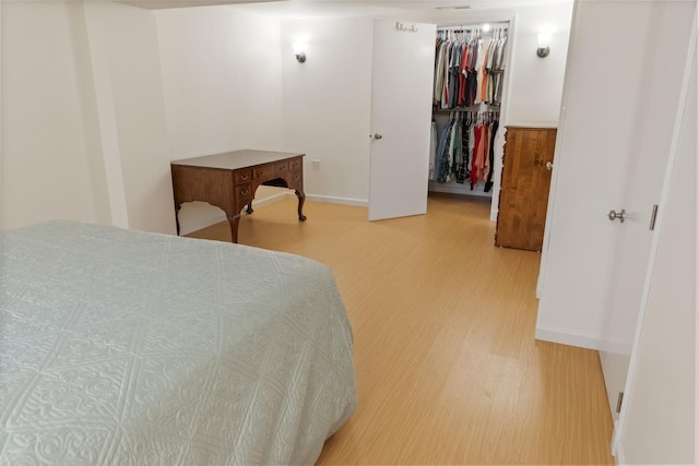509 Waverly Ave, Streamwood, IL 60107 - bedroom featuring light wood finished floors and a walk in closet