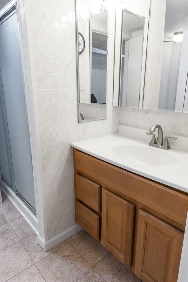 509 Waverly Ave, Streamwood, IL 60107 - full bathroom with vanity, a shower stall, tile walls, and tile patterned floors
