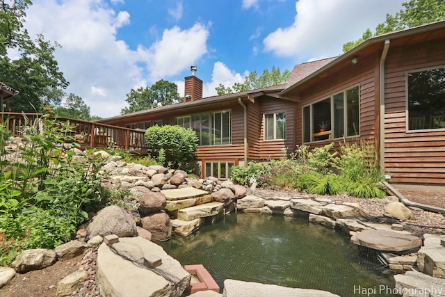 24099 W Haidi Ln, Lake Villa, IL 60046 - back of house featuring a chimney and a small pond