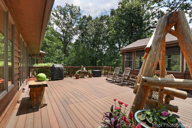 24099 W Haidi Ln, Lake Villa, IL 60046 - wooden terrace with a sunroom, grilling area, outdoor dining space, and view of wooded area