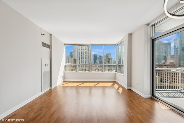 330 W Grand Ave Unit 1101, Chicago, IL 60654 - empty room featuring a skyline view and wood finished floors