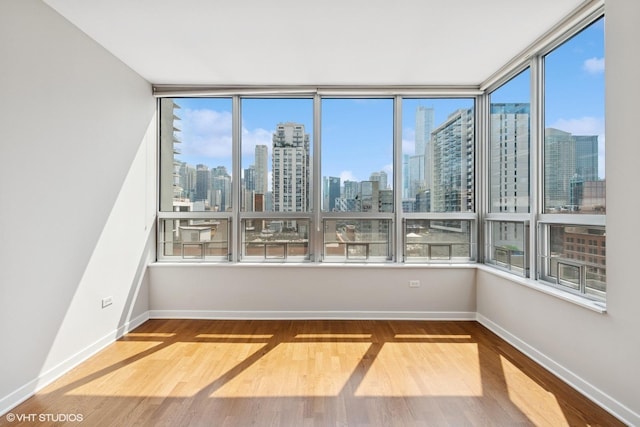 330 W Grand Ave Unit 1101, Chicago, IL 60654 - unfurnished room with a view of skyline and wood finished floors