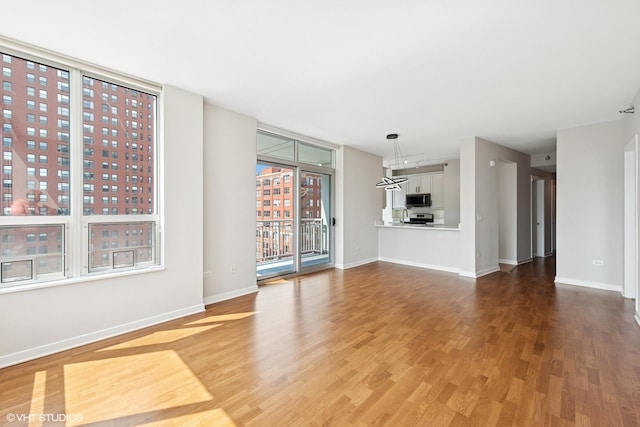 330 W Grand Ave Unit 1101, Chicago, IL 60654 - unfurnished living room with wood finished floors and baseboards