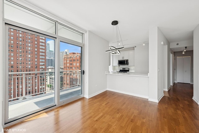 330 W Grand Ave Unit 1101, Chicago, IL 60654 - unfurnished dining area featuring wood finished floors, a city view, and a chandelier