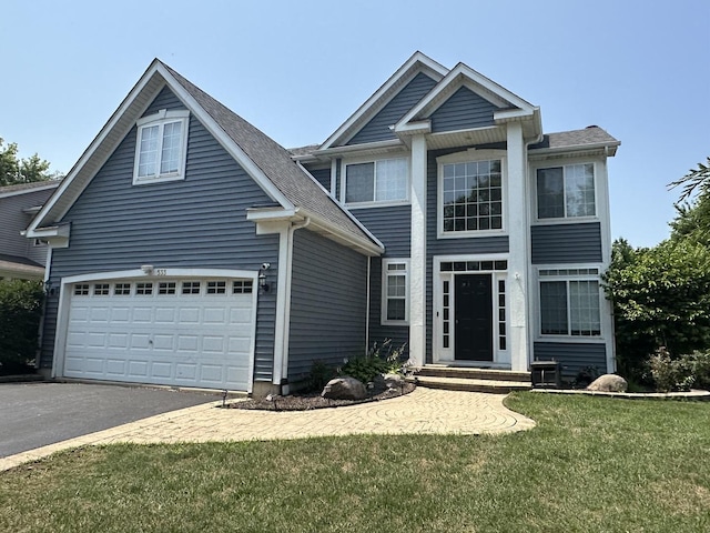533 Jackson Blvd, Grayslake, IL 60030 - view of front facade featuring driveway, a garage, a front lawn, and a shingled roof