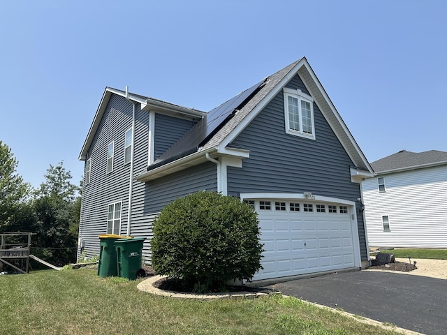 533 Jackson Blvd, Grayslake, IL 60030 - view of side of property featuring driveway, roof mounted solar panels, and a garage