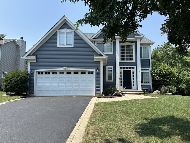 533 Jackson Blvd, Grayslake, IL 60030 - traditional-style home with driveway, a front yard, and a garage