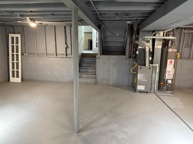 3018 20th St, North Chicago, IL 60064 - unfinished below grade area featuring water heater, stairway, and heating unit